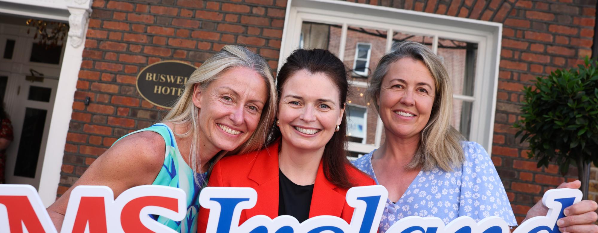 MS Ireland representatives at Leinster House holding an MS Ireland sign during the Budget 2027 campaign launch.