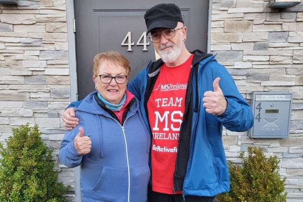 Mother and Son standing in front of doorway wearing MS Ireland red t-shirt with logo