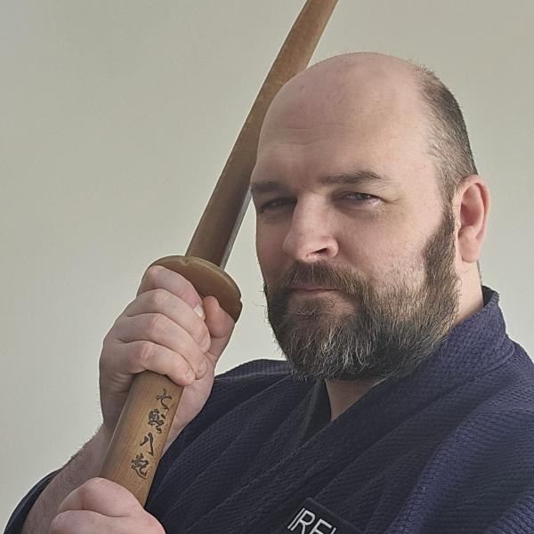 Paul holding a wooden martial arts training sword (bokutō)