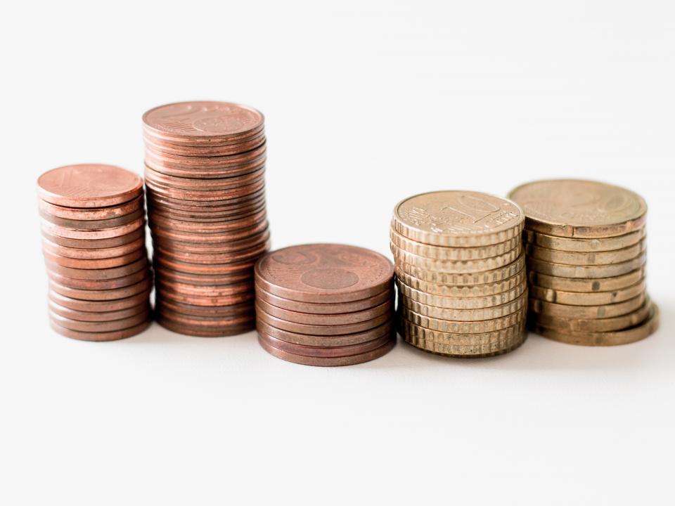 Several stacks of coins arranged in piles, showcasing different heights and sizes.