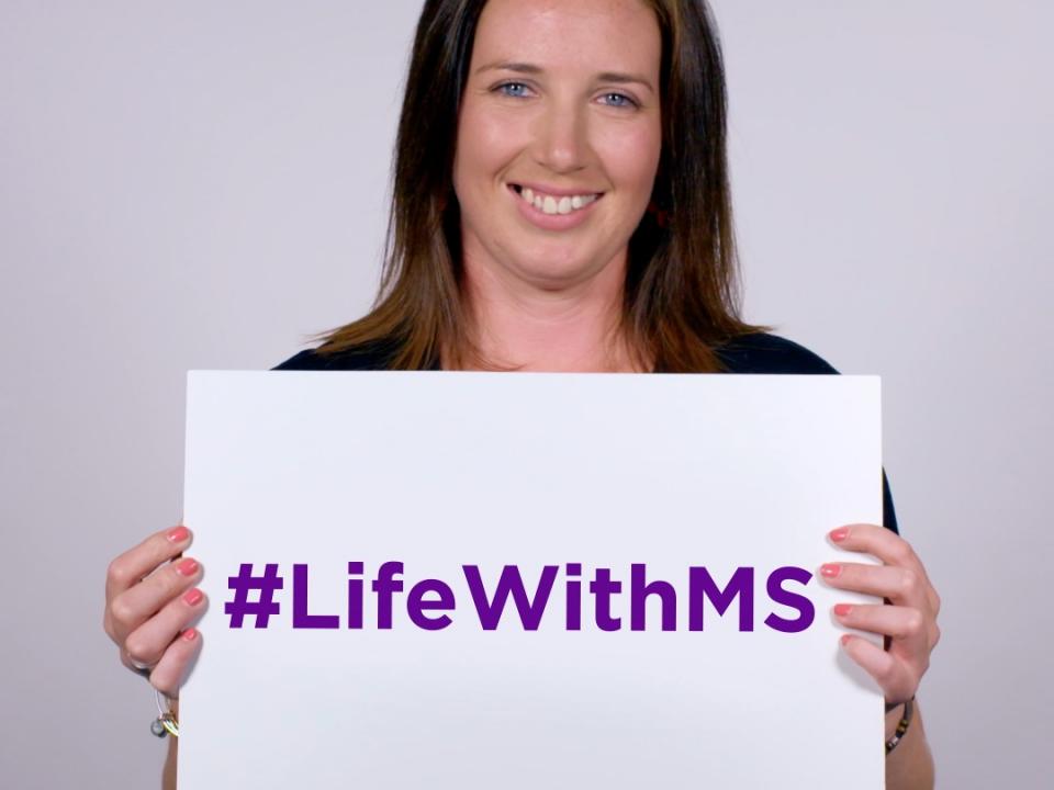 Woman holding a sign that says #LifeWithMS