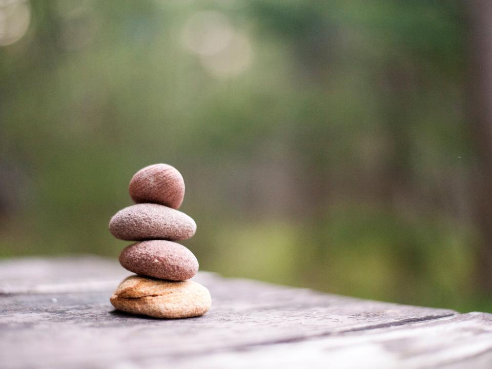 A small stack of 5 rocks with a blurred background. 