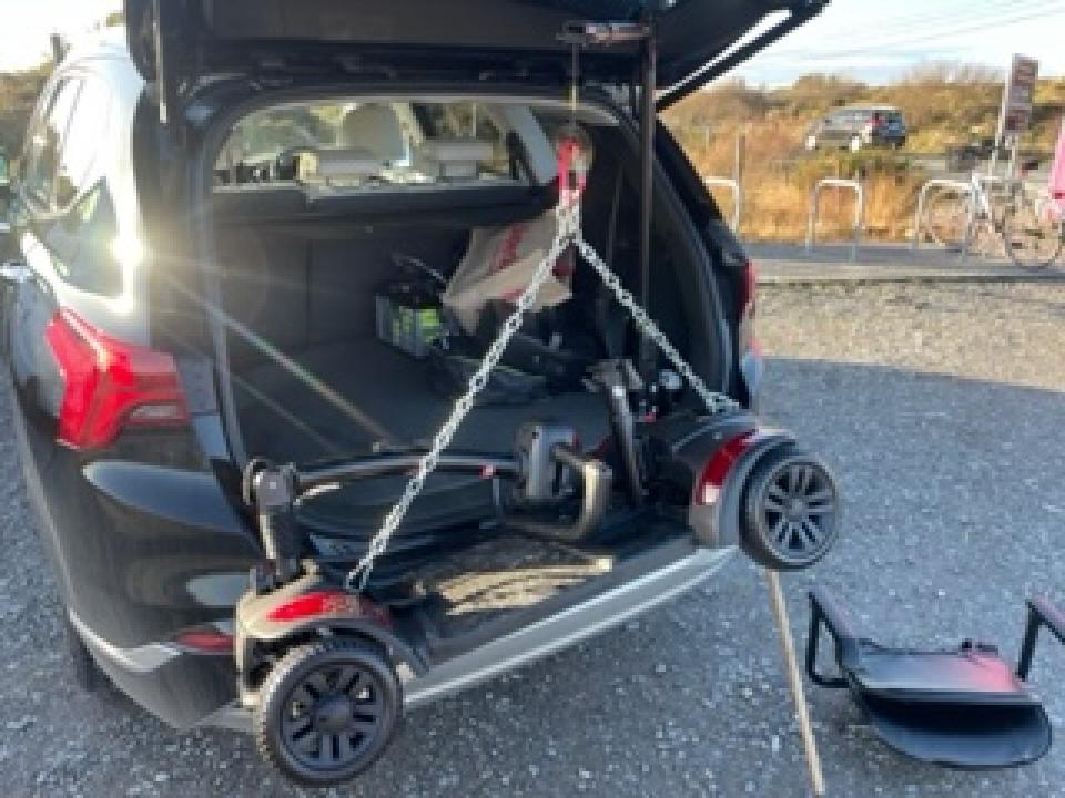 A mobility Scooter going in to a car booth