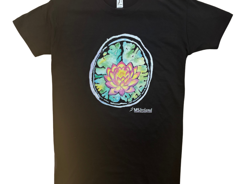 lack T-shirt featuring a vibrant, artistic design of a brain scan with a colorful lotus flower at its centre, the logo “MS Ireland” is printed below the design.