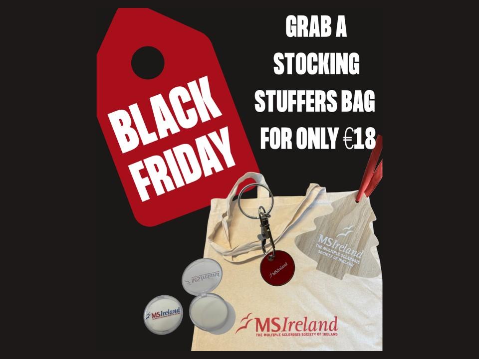 Black Friday promotion showing an MS Ireland Stocking Stuffers Bag with tote bag, keyring token, soap leaves and wooden tree ornament for €18.