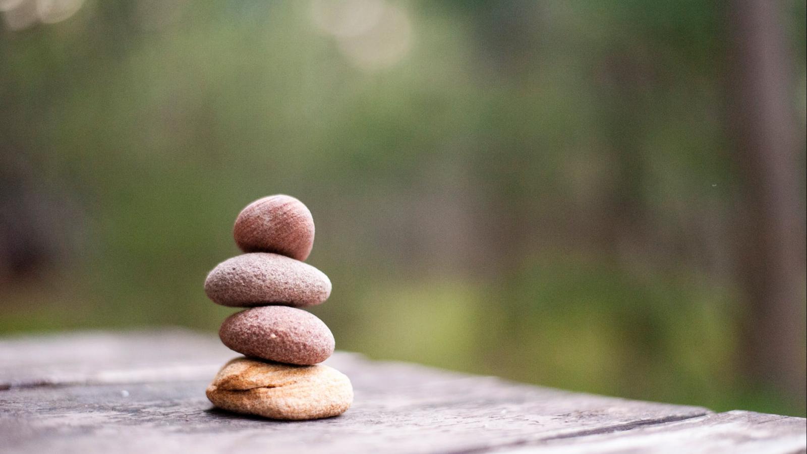 A small stack of 5 rocks with a blurred background. 
